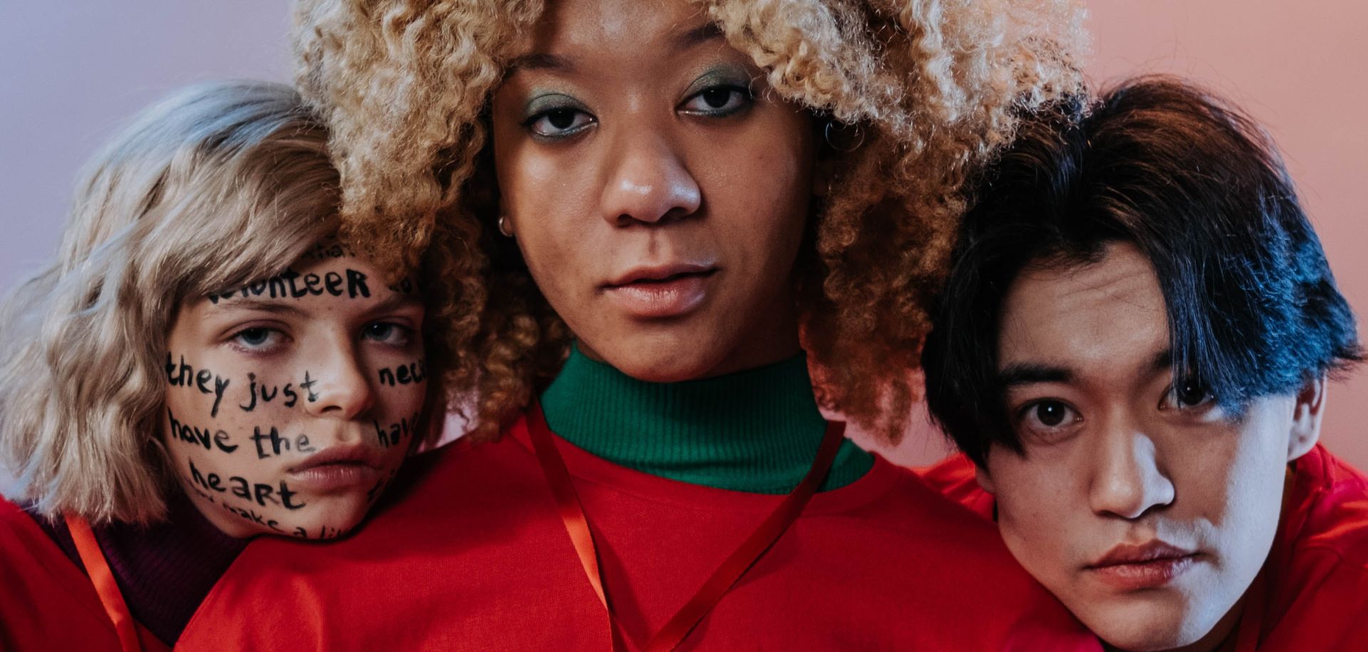 Three People in Red Crew Neck Shirt Uniform